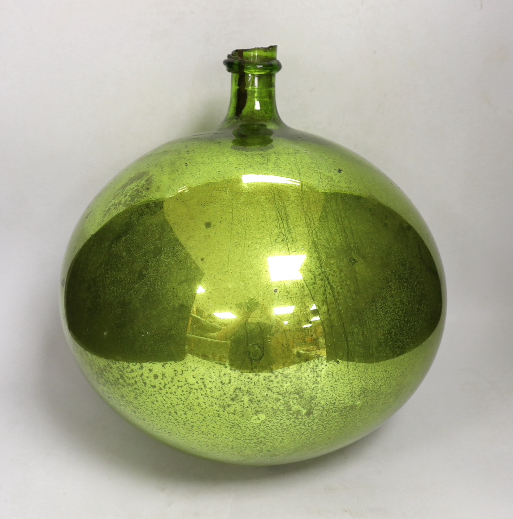 A large metallic lime green witches ball, 34cm high
